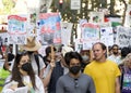 Participants holding signs marching and protesting APEC meeting in San Francisco, CA