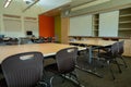 Empty grade school classroom with Apple Mac computer in back