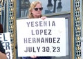 Participants holding signs of recently murdered women at a Domestic Violence Awareness Month Rally