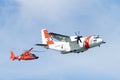 Coast Guard helicopter and plane flying in air show