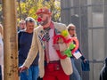 A unidentified man dressed clown amuse people near cable car