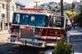 San Francisco, CA, USA - Sep 13, 2023: Classic 1990s firetruck parked in the firehouse on one of San Francisco\'s streets.