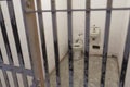 Tourists visiting Alcatraz prison and the main corridor with ordinary single cells on ground level. San Francisco historical landm