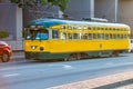San Francisco, California - August 6, 2017: Yellow vintage city tram speeds up at The Embarcadero
