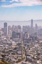 Hazy afternoon view of the San Fransisco skyline looking down Market Street towards the Ferry Building from Twin Peaks.