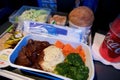 SAN FRANCISCO, CALIFORNIA, UNITED STATES - NOV 24th, 2018: Hot food served on board of economy class airplane on table