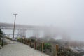 SAN FRANCISCO, CALIFORNIA, UNITED STATES - 30 October 2022: View of Golden Gate bridge hidden completely by fog Royalty Free Stock Photo