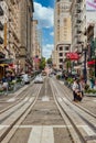 San Francisco, California, USA - June 15, 2015: Cable car climbs the popular street hill in the busy central area of Union Square Royalty Free Stock Photo