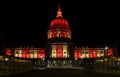 San Francisco City Hall lit in red and gold at night Royalty Free Stock Photo