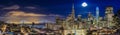 San Francisco downtown skyline sunset panorama with Bay Bridge and full moon between skyscrapers from Ina Coolbirth park