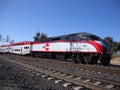 Caltrain Commuter Train moves along tracks during the day