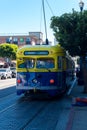 San Francisco muni railroad streetcar painted in yellow and blue colors