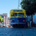 San Francisco muni railroad streetcar painted in yellow and blue colors