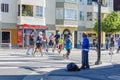 San Francisco Road Race Vendor on street corner as racers run by him.