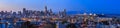 San Francisco skyline night panorama with city lights, the Bay Bridge and light trails on the highway Royalty Free Stock Photo