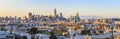 San Francisco skyline panorama just before sunset with city lights, the Bay Bridge and highway leading into the city Royalty Free Stock Photo