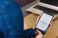 SAN FRANCISCO, US - 22 April 2019: Close up to female hands holding smartphone Creating Project Plan by Google Docs Application,