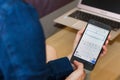 SAN FRANCISCO, US - 22 April 2019: Close up to female hands holding smartphone using Google Slides application, San Francisco,