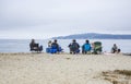 Families meat at the sandy beach and relax near San Francisco