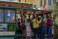 San Francisco, USA - July 18, 2019, people hang and take pictures of the sights in the old tram on the cable car in the city of