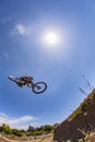 Jumps with his dirt bike over the ramp at an artificial trial