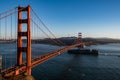 San Francisco, USA - November 2017: Golden Gate Bridge and a big barge floats under it. Royalty Free Stock Photo