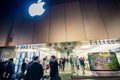 People meet at the entrance to the Apple Store