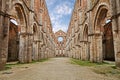 San Galgano abbey in Chiusdino, Siena, Tuscany, Italy. Roofless nave with colonnade of the medieval Gothic style church. Royalty Free Stock Photo