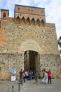 Tourists pass through the San Giovanni gate