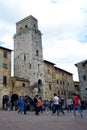 SAN GIMIGNANO, ITALY - 04 02 2014: Tourists walk in San Gimignano - children play football in the square. Historic Centre of San Royalty Free Stock Photo