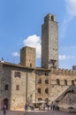 SAN GIMIGNANO, ITALY - OCTOBER 8, 2018: Medieval buildings, tower and the old well on the central square Piazza Della Cisterna Royalty Free Stock Photo