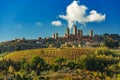 the towers of San Gimignano standing tall above an autumn vineya