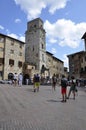 San Gimignano, 25th august: Tourists visiting Plaza Cisterna Square from Medieval San Gimignano hilltop town. Tuscany. Italy Royalty Free Stock Photo