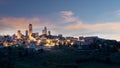 San Gimignano town skyline and medieval towers sunset sky scene in  Italian olive trees in foreground. Tuscany, Italy Royalty Free Stock Photo