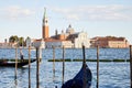 San Giorgio Maggiore basilica with gondola passing in Venice at sunset, Italy