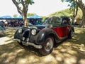 Old black and red 1943 Riley RMB 2.5 in a park. Nature, trees. Autoclasica 2022 classic car show Royalty Free Stock Photo