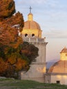 San Lorenzo bell tower and dome, Portovenere, Liguria, ITaly. Beautiful winter evening sunset. Royalty Free Stock Photo