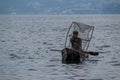 SAN MARCOS LA LAGUNA, GUATEMALA - MARCH 24, 2016: Fisherman on traditional wooden boats on Atitlan lake near San Marcos