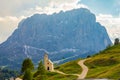 San Maurizio chapel on the passo di val Gardena with mountain view in background. Colorful view in pass Sella in summer sunny day