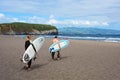 A man and a girl are skating on a surfboard. Beautiful beach of Praia do Areal de Santa Barbara, San Miguel, Azores.