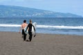 San Miguel, Portugal, June 2019. A man and a girl are skating on a surfboard. Beautiful beach of Praia do Areal de Santa Barbara,