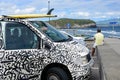 San Miguel, Portugal, June 2019. Painted car with a surfboard on the beach of Praia do Areal de Santa Barbara, San Miguel, Azores