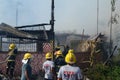 Firemen and volunteers working extinguishing fire on a subdivision house