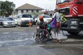 Blind man pushing wheelchair of disabled beggar