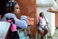 wheelchair beggar receiving Christmas gift alms at church yard