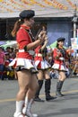 Band majorette with massive thighs and legs dances using worn out boots on street Royalty Free Stock Photo