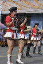 Band majorette with massive thighs and legs dances using worn out boots on street Royalty Free Stock Photo