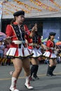 Band majorette with massive thighs and legs dances using worn out boots on street Royalty Free Stock Photo