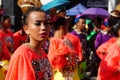 Female carnival dancer in ethnic costumes grimaces under hot sun