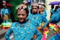 Girl carnival dancer in ethnic costumes dances in delight along the road